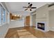 Open-concept living room boasts hardwood floors, fireplace, and views into the kitchen at 5244 Velazco Ln, Las Vegas, NV 89130