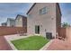 This backyard features a patio with a seating area, artificial turf, and desert landscaping at 5256 Sherwood Forest Ln, Las Vegas, NV 89122