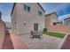 This backyard features a patio with a seating area, artificial turf, and desert landscaping at 5256 Sherwood Forest Ln, Las Vegas, NV 89122