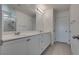 This bathroom features double sinks, white cabinets, and a tile floor at 5256 Sherwood Forest Ln, Las Vegas, NV 89122