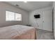 This bedroom features a plush carpet, a window and a TV at 5256 Sherwood Forest Ln, Las Vegas, NV 89122
