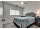 Cozy bedroom featuring a ceiling fan, plush carpeting, and a comfortable gray bedspread at 5256 Sherwood Forest Ln, Las Vegas, NV 89122