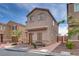Inviting two-story house featuring desert landscaping, neutral colors, and a cozy front porch at 5256 Sherwood Forest Ln, Las Vegas, NV 89122