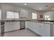 Modern kitchen with white cabinets, granite countertops, and stainless appliances at 5256 Sherwood Forest Ln, Las Vegas, NV 89122