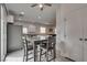 Bright kitchen area features gray-toned table set, stainless steel refrigerator, and tile flooring at 5256 Sherwood Forest Ln, Las Vegas, NV 89122