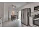 Eat-in kitchen features stainless appliances, white cabinets, and backyard access at 5256 Sherwood Forest Ln, Las Vegas, NV 89122