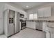 Modern kitchen with white cabinets, stainless steel appliances, and granite countertops at 5256 Sherwood Forest Ln, Las Vegas, NV 89122