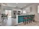 Bright kitchen with stainless steel appliances, white cabinets, island seating, and backyard access at 5256 Sherwood Forest Ln, Las Vegas, NV 89122