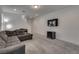 Open living room features grey sofa, mounted television, and lots of natural light at 5256 Sherwood Forest Ln, Las Vegas, NV 89122