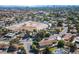 Wide aerial view capturing the community, nearby arena and mountains in the background at 5518 Avenida Vaquero, Las Vegas, NV 89108