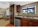 A charming kitchen area with stainless steel appliances, granite counters, and a bright window above the sink at 5518 Avenida Vaquero, Las Vegas, NV 89108