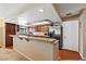 Beautiful kitchen featuring granite countertops, wood cabinets, stainless steel appliances, and wood flooring accents at 5518 Avenida Vaquero, Las Vegas, NV 89108