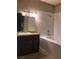 A bathroom features a tile shower, tile floor, and dark cabinet with a marble countertop at 5525 W Flamingo Rd # 2037, Las Vegas, NV 89103