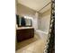 Bathroom with a vanity, mirror, decorative lights, and a tiled shower-bathtub combination at 5525 W Flamingo Rd # 2037, Las Vegas, NV 89103