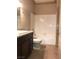 A well lit bathroom with a tiled shower, tile floor and a dark cabinet with a light countertop at 5525 W Flamingo Rd # 2037, Las Vegas, NV 89103