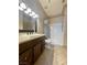 Updated bathroom featuring a dark wood vanity, tile floors and shower-tub combo at 5525 W Flamingo Rd # 2037, Las Vegas, NV 89103