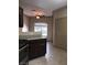 This kitchen shows dark cabinets with lots of countertop space and a view to the outdoors at 5525 W Flamingo Rd # 2037, Las Vegas, NV 89103