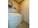 Bright laundry room with tile floors, shelf and side-by-side washer and dryer at 5525 W Flamingo Rd # 2037, Las Vegas, NV 89103