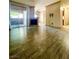 Bright living room with wood-look floors, sliding glass doors, balcony, fireplace and neutral paint at 5525 W Flamingo Rd # 2037, Las Vegas, NV 89103