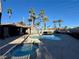 Outdoor pool with hot tub and shaded seating area, surrounded by tropical palm trees at 5525 W Flamingo Rd # 2037, Las Vegas, NV 89103