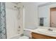 Bright bathroom features a shower-tub combo with decorative shower curtain at 6048 Pele St, North Las Vegas, NV 89031