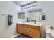 Bathroom featuring a double sink vanity with a large mirror at 6048 Pele St, North Las Vegas, NV 89031