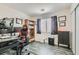 Bedroom features neutral walls, dark wood floors, and gaming chair at 6048 Pele St, North Las Vegas, NV 89031