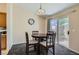 Cozy dining area adjacent to the kitchen, featuring a wooden table and chairs, with sliding door to outside at 6048 Pele St, North Las Vegas, NV 89031