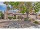 Charming single-story home featuring desert landscaping, a tiled roof, and an attached two-car garage at 6048 Pele St, North Las Vegas, NV 89031