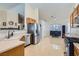 Spacious kitchen with stainless steel appliances, island sink, and tile flooring at 6048 Pele St, North Las Vegas, NV 89031