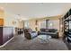 Inviting living area with comfortable seating, large windows, and carpeted floors, perfect for relaxing at 6048 Pele St, North Las Vegas, NV 89031