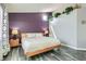 Cozy main bedroom with accent wall and plants on a ledge above at 6048 Pele St, North Las Vegas, NV 89031