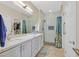 Bathroom featuring double sinks, a tiled shower, and modern fixtures at 6072 Canter Glen Ave, Las Vegas, NV 89122