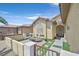 Inviting front porch featuring a seating area, manicured synthetic lawn, and decorative metal gate at 6072 Canter Glen Ave, Las Vegas, NV 89122