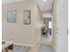 Inviting hallway with neutral tones, a mirror, and decorative art create a welcoming ambiance at 6072 Canter Glen Ave, Las Vegas, NV 89122