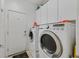 Functional laundry room features a modern washer and dryer, cabinets for storage and a door at 6072 Canter Glen Ave, Las Vegas, NV 89122