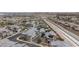 Aerial view showcasing a residential community with solar panels, a neighborhood pool, and modern home designs at 6148 Juniper Grove St, Las Vegas, NV 89148
