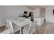Dining area featuring a modern white table and chairs near the kitchen at 6148 Juniper Grove St, Las Vegas, NV 89148
