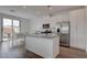 Bright, modern kitchen featuring stainless steel appliances, granite countertops, and hardwood floors at 6148 Juniper Grove St, Las Vegas, NV 89148
