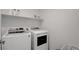 Laundry room featuring a modern washer and dryer, with shelving for storage at 6148 Juniper Grove St, Las Vegas, NV 89148
