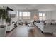 Modern living room featuring wood floors, large windows, and stylish contemporary furnishings at 6148 Juniper Grove St, Las Vegas, NV 89148