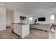 Open concept space showcasing the kitchen island, living room, and ample natural light at 6148 Juniper Grove St, Las Vegas, NV 89148