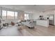 Sun-filled living room with modern decor, open to the kitchen with stainless steel appliances at 6148 Juniper Grove St, Las Vegas, NV 89148