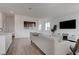 Bright living room with modern decor, large windows, and wood flooring at 6148 Juniper Grove St, Las Vegas, NV 89148