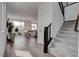 Bright, airy living room with hardwood floors, lots of natural light, and open staircase at 6148 Juniper Grove St, Las Vegas, NV 89148