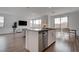 Spacious living area with stainless steel kitchen appliances and dining area, filled with natural light at 6148 Juniper Grove St, Las Vegas, NV 89148