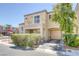 Tan two-story home with a balcony over the entryway and an attached two-car garage at 6217 Lapilli Ave, Las Vegas, NV 89139