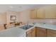 Kitchen with stainless steel sink, wood cabinets, and a dining area at 6217 Lapilli Ave, Las Vegas, NV 89139