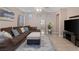 Inviting living room with hardwood floors, a large sectional sofa, and plenty of natural light at 6217 Lapilli Ave, Las Vegas, NV 89139