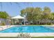 Sparkling community pool with a shaded gazebo area, surrounded by lush landscaping and a secure fence at 6217 Lapilli Ave, Las Vegas, NV 89139